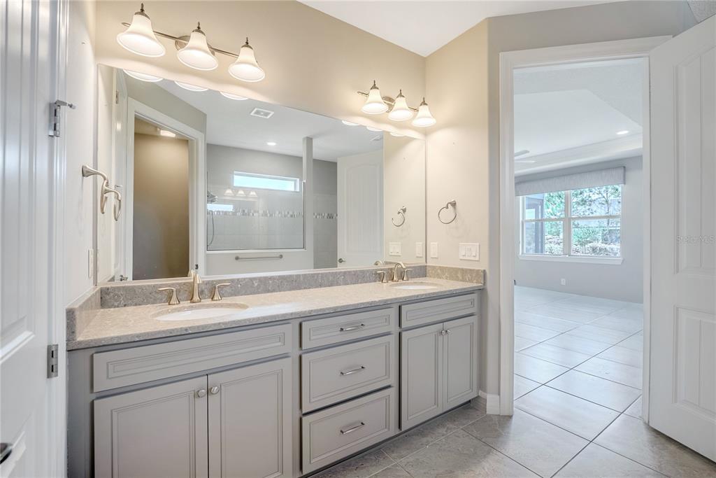 9550 Southwest 64th Lane Ocala, FL 34481 - Photo 35 of 58 a bathroom with a double vanity sink and a mirror