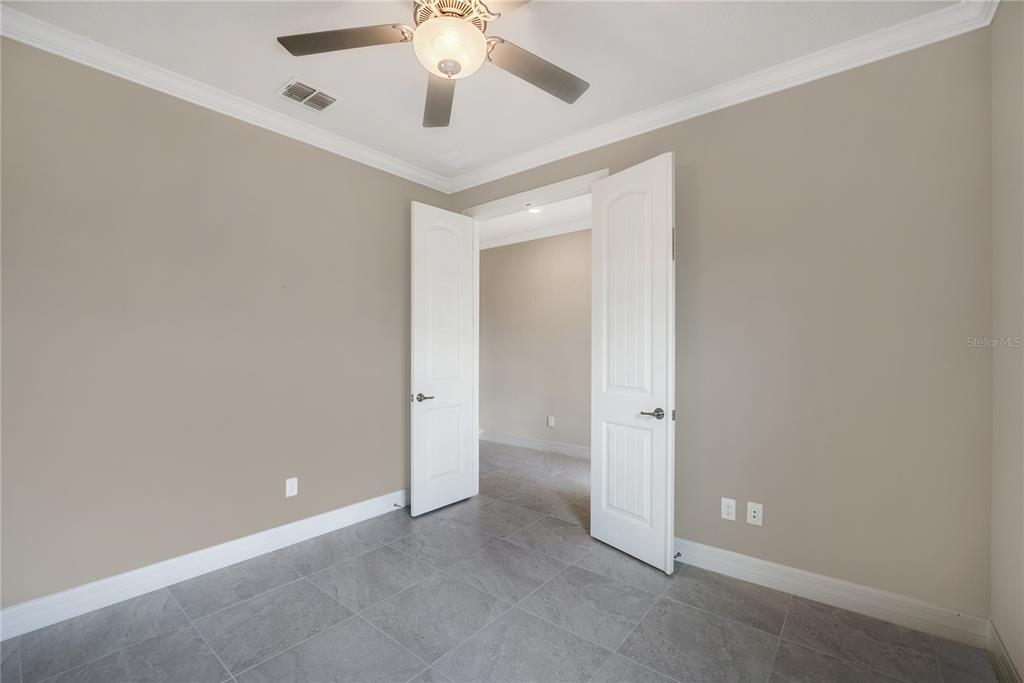 9550 Southwest 64th Lane Ocala, FL 34481 - Photo 7 of 58 an empty room with a chandelier fan and closet area