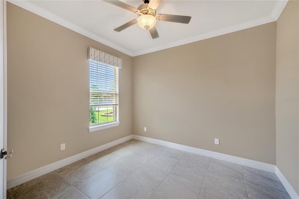 9550 Southwest 64th Lane Ocala, FL 34481 - Photo 9 of 58 an empty room with a window and a fan