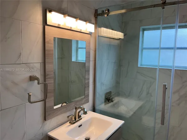 a bathroom with a sink and shower