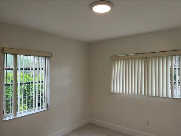 a view of empty room with windows