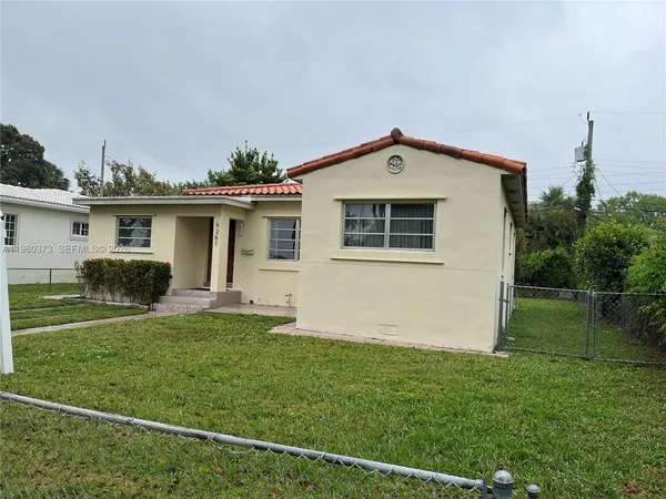 a front view of house with yard and green space