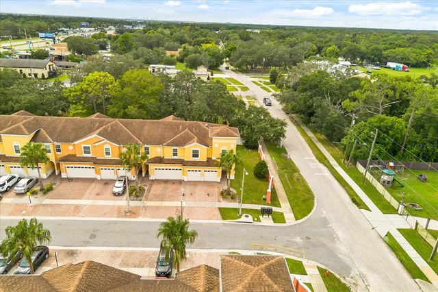 an aerial view of residential houses with outdoor space and swimming pool