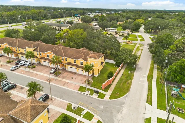 an aerial view of residential houses with outdoor space and swimming pool
