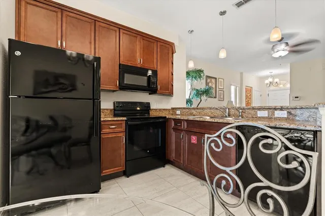 a kitchen with a stove a refrigerator and a sink