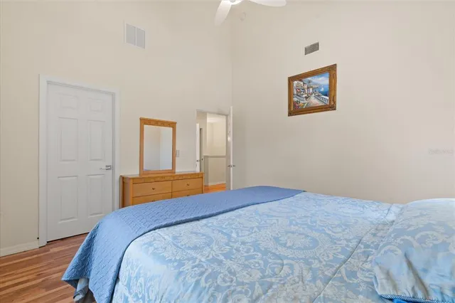 a bedroom with a bed and painting on the wall