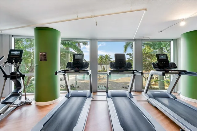 a view of a living room and bedroom with furniture large windows and garden view