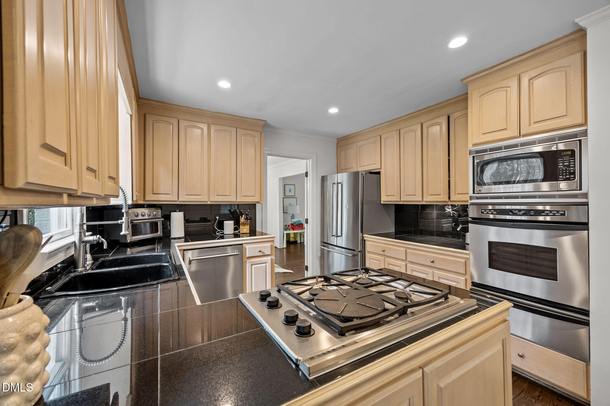 1120 Queensferry Road Cary, NC 27511 - Photo 13 of 62 a kitchen with a stove a sink and a refrigerator