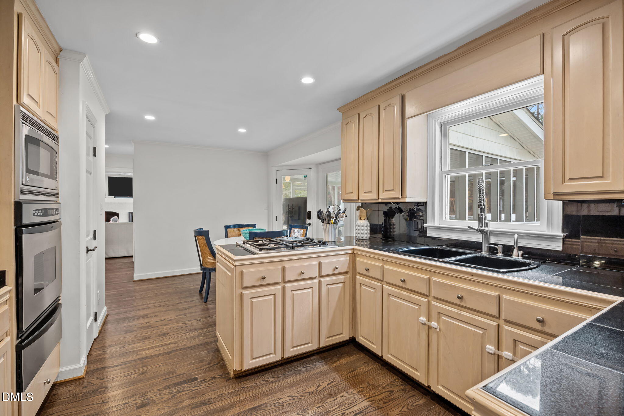 1120 Queensferry Road Cary, NC 27511 - Photo 15 of 62 a kitchen with white cabinets sink and stainless steel appliances