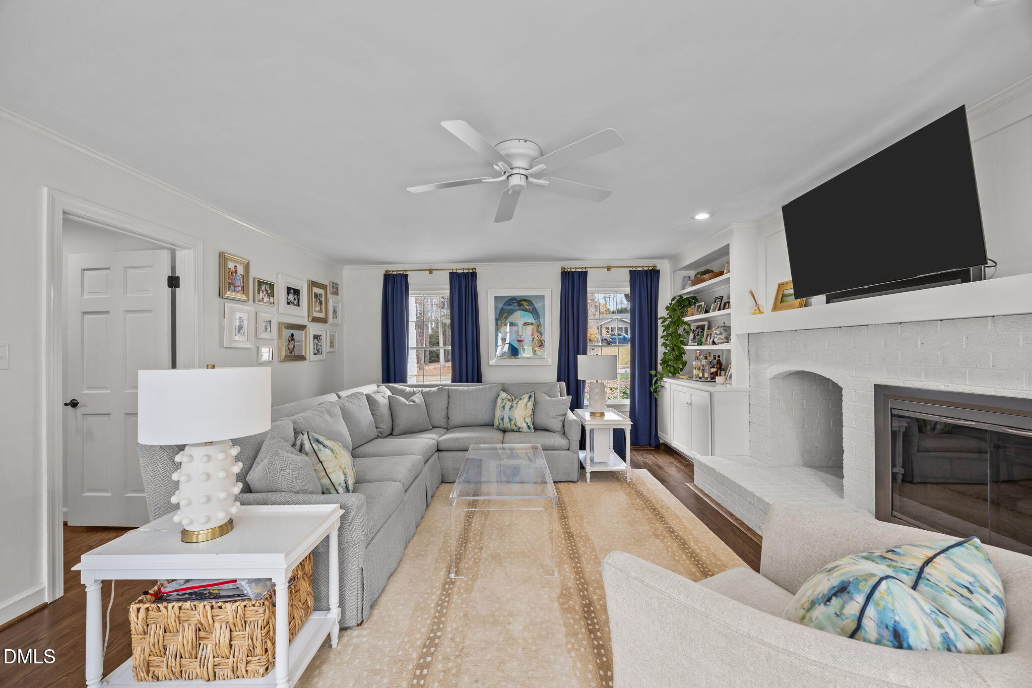 1120 Queensferry Road Cary, NC 27511 - Photo 22 of 62 a living room with furniture a fireplace and a flat screen tv