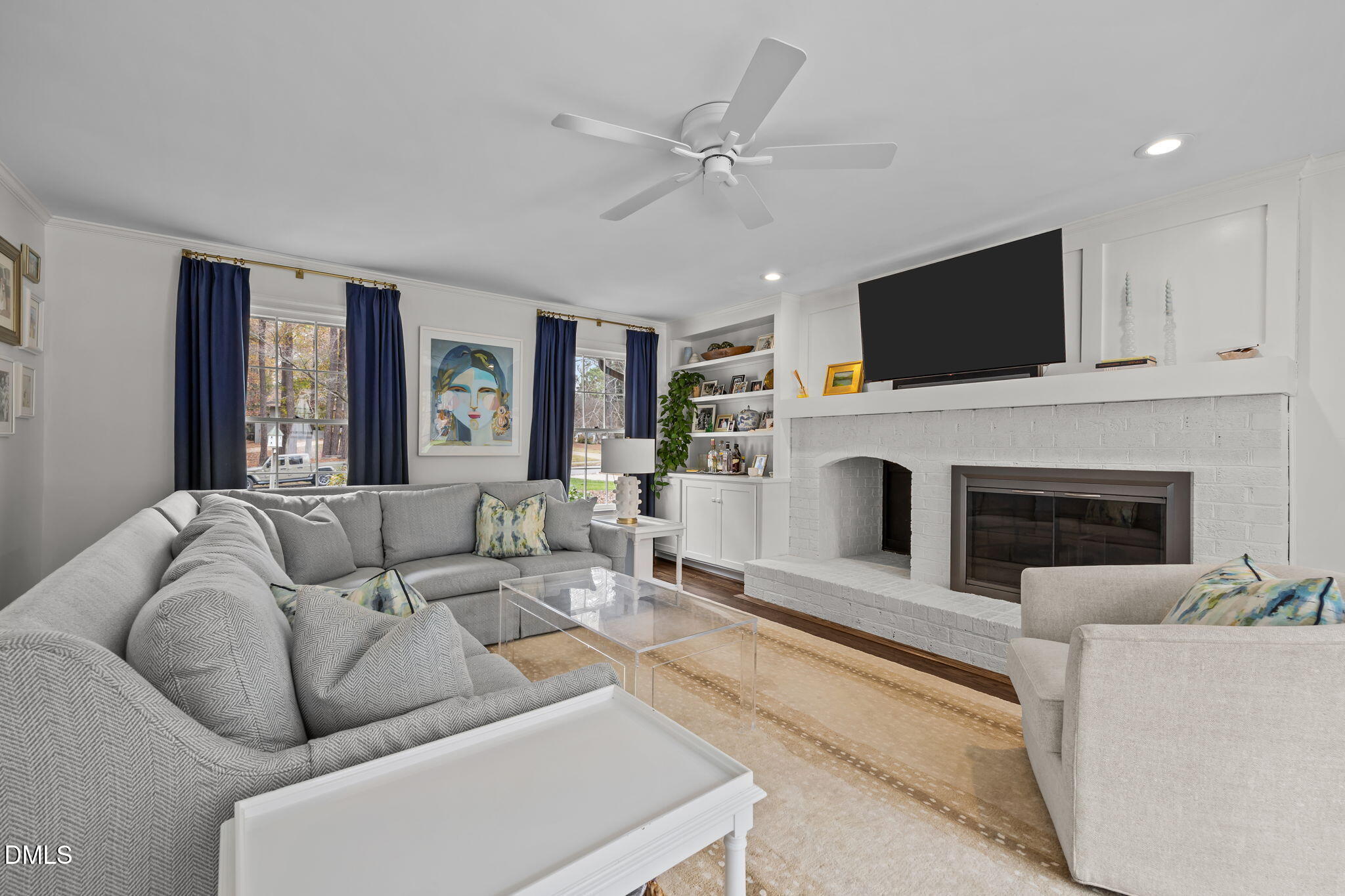 1120 Queensferry Road Cary, NC 27511 - Photo 23 of 62 a living room with furniture a fireplace and a flat screen tv