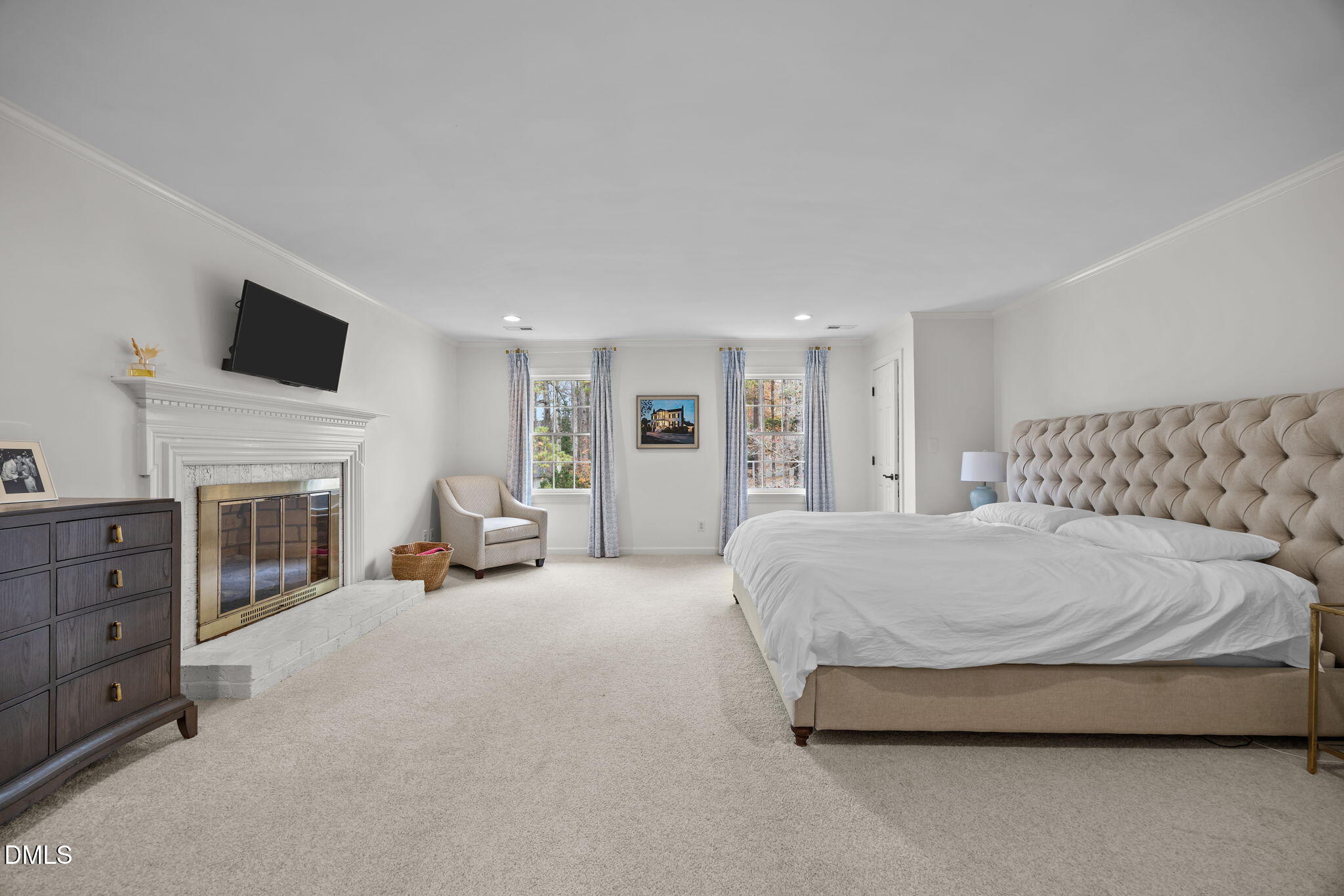1120 Queensferry Road Cary, NC 27511 - Photo 26 of 62 a spacious bedroom with a bed and a fireplace