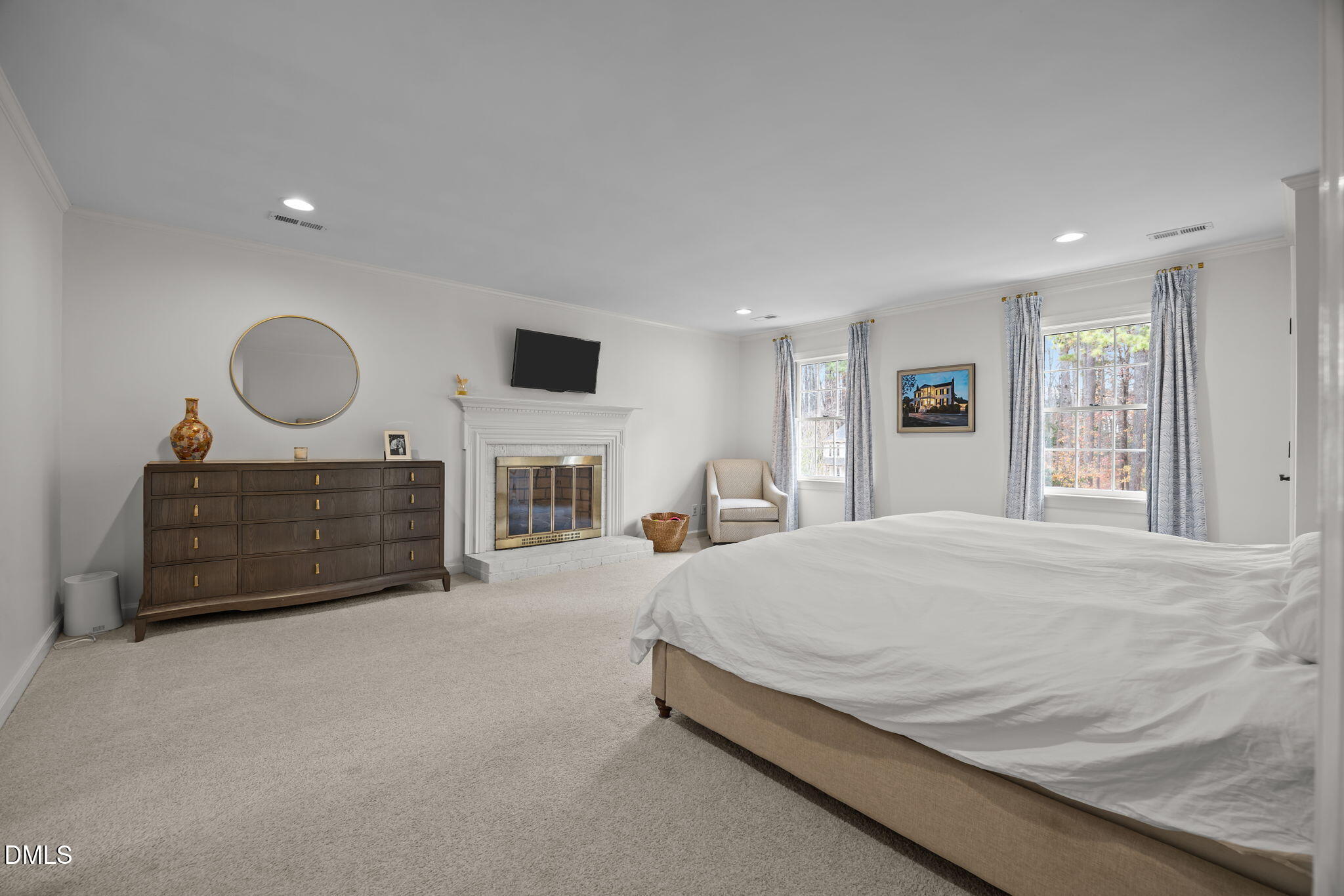 1120 Queensferry Road Cary, NC 27511 - Photo 28 of 62 a spacious bedroom with a bed a fireplace and a large window
