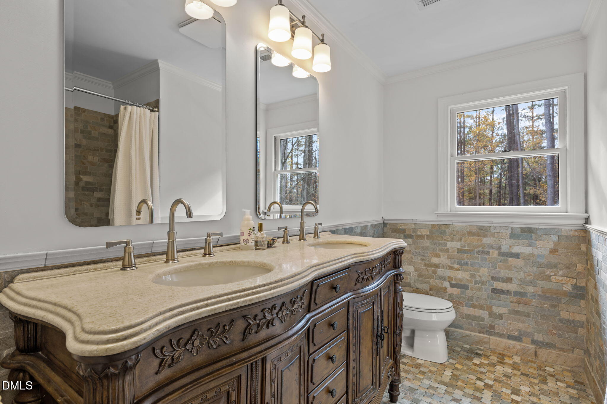 1120 Queensferry Road Cary, NC 27511 - Photo 36 of 62 a bathroom with a sink a toilet and a mirror