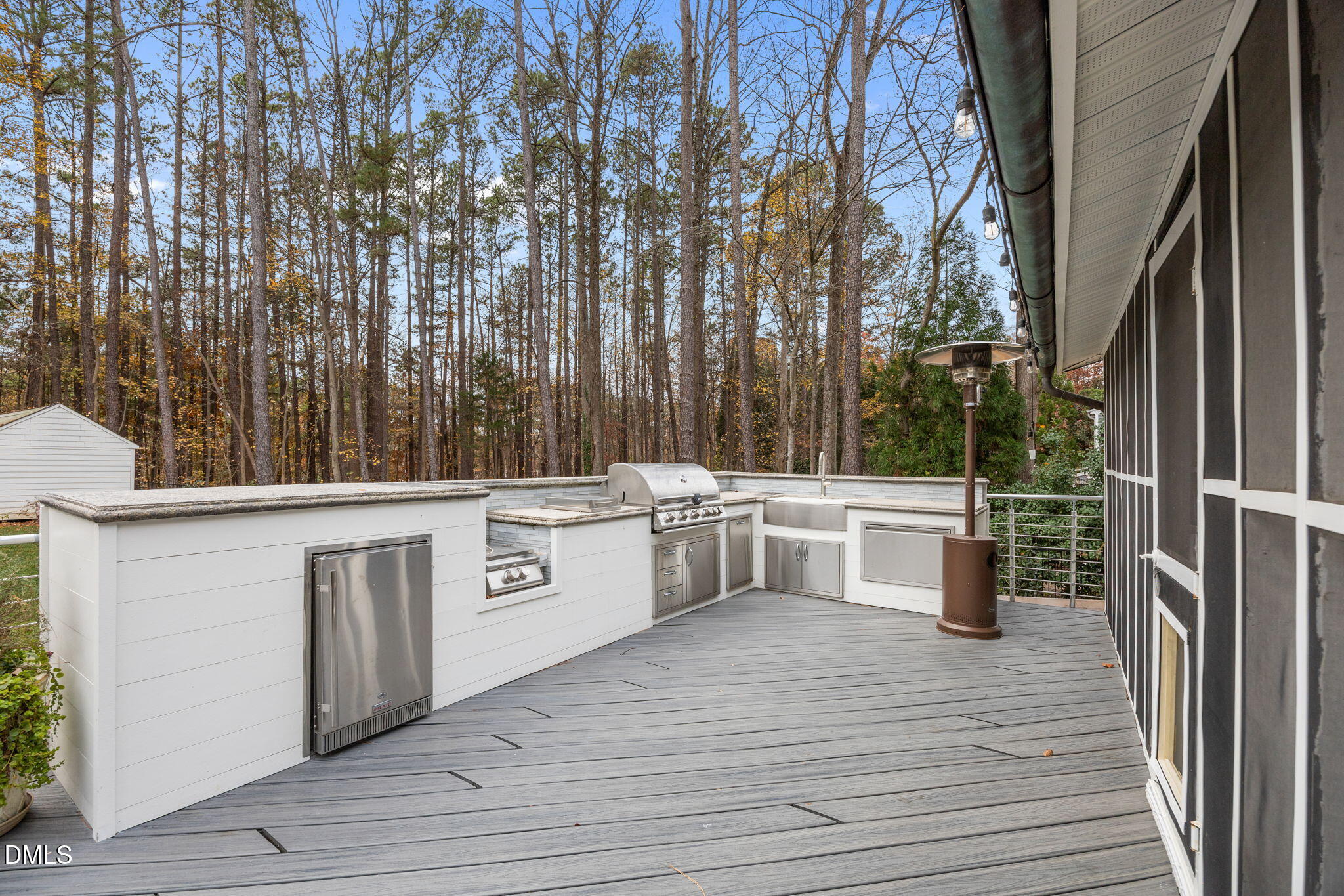 1120 Queensferry Road Cary, NC 27511 - Photo 47 of 62 a view of a kitchen with stainless steel appliances wooden floors and wooden fence