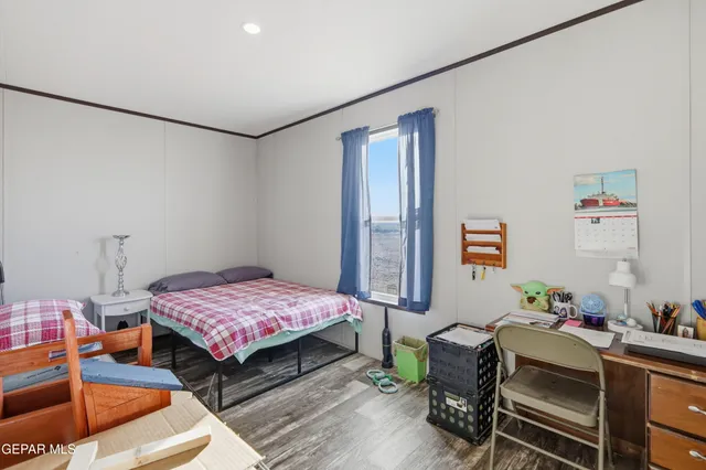 a bedroom with furniture and a wooden floor