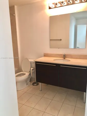 a bathroom with a sink a toilet and mirror