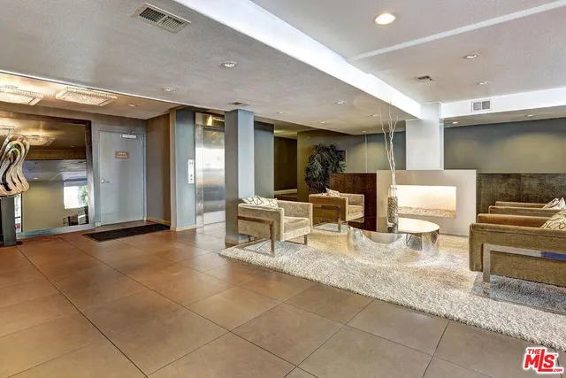 a lobby with furniture and a potted plant