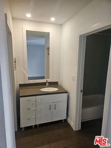 a bathroom with a sink a mirror and a shower