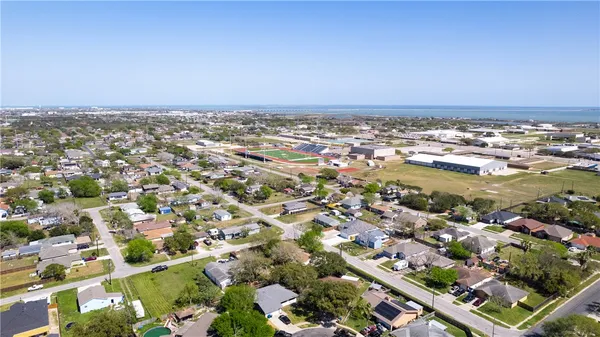 an aerial view of residential building and ocean