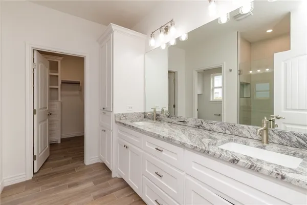 a bathroom with a granite countertop sink double and mirror