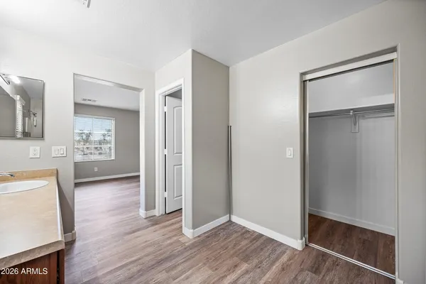 an empty room with wooden floor and a fireplace