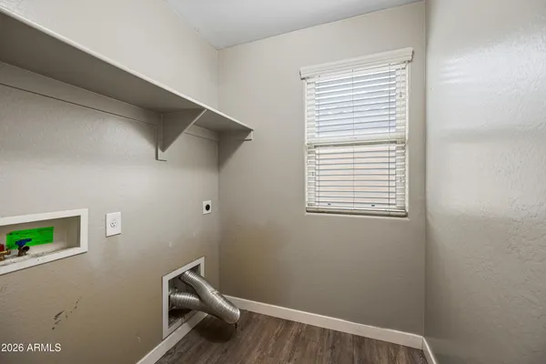 a view of a room with a window and wooden floor