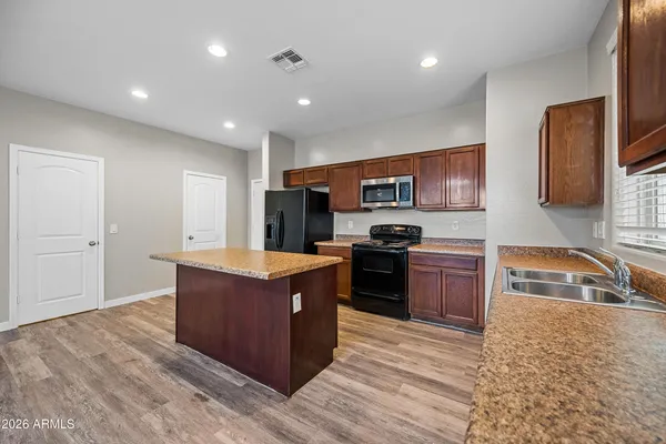 a kitchen with stainless steel appliances granite countertop a stove top oven and a sink with granite countertops