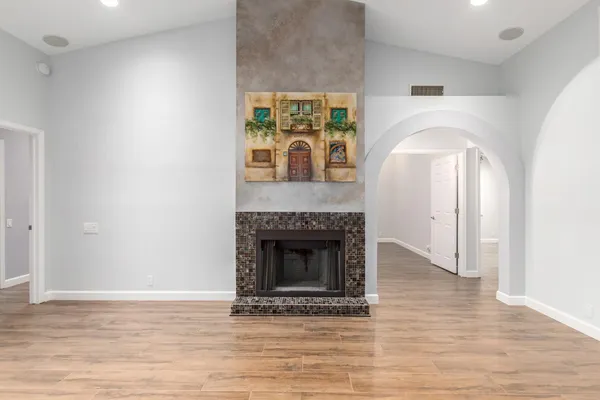 a view of an empty room with window and fireplace