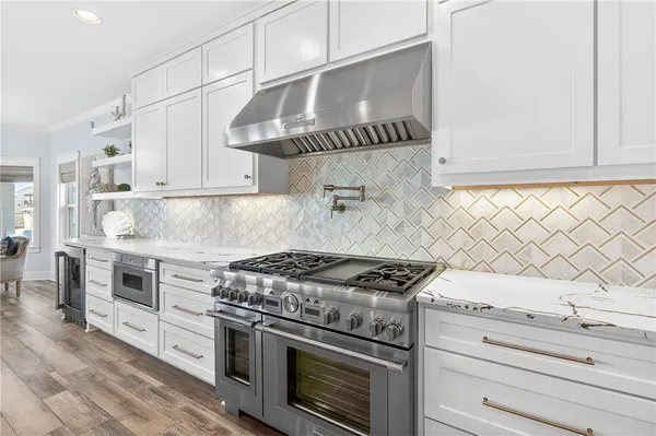 a kitchen with granite countertop a stove and a sink