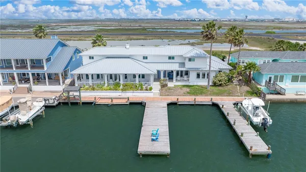an aerial view of a house with swimming pool and a yard