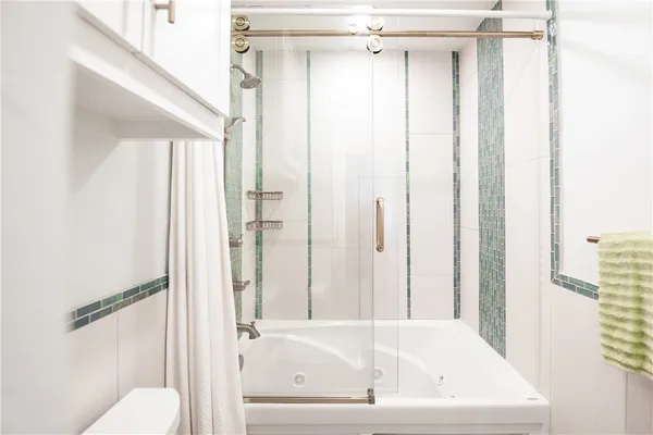 a bathroom with a tub and shower