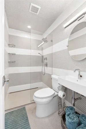 a bathroom with a toilet a sink and shower
