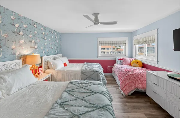 a bedroom with two beds and a window