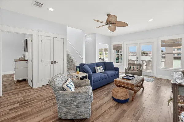 a living room with furniture and a wooden floor