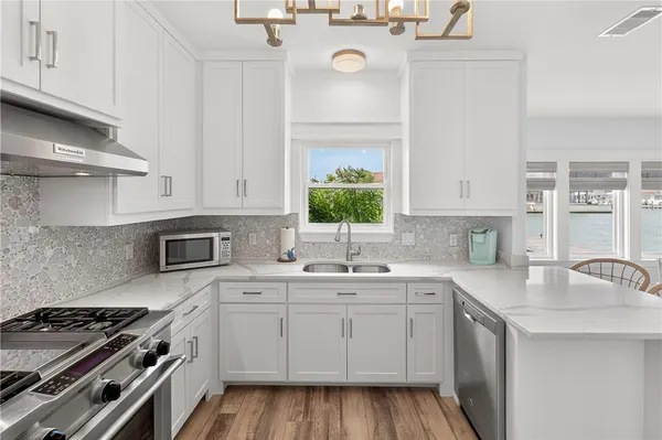 a kitchen with a sink stove top oven and cabinets