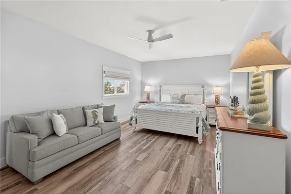 a bedroom with furniture and a wooden floor