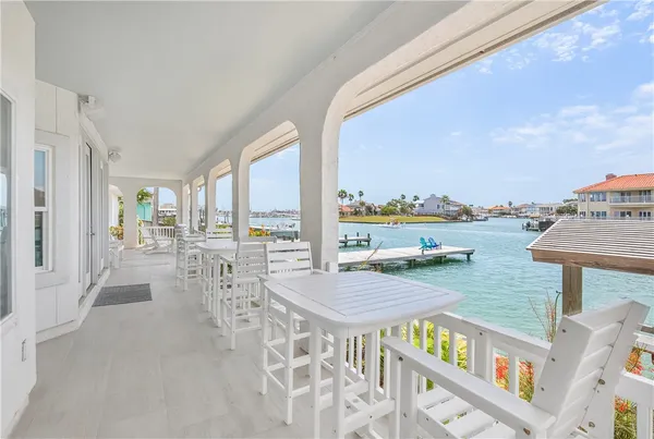 a view of a patio with swimming pool and ocean view
