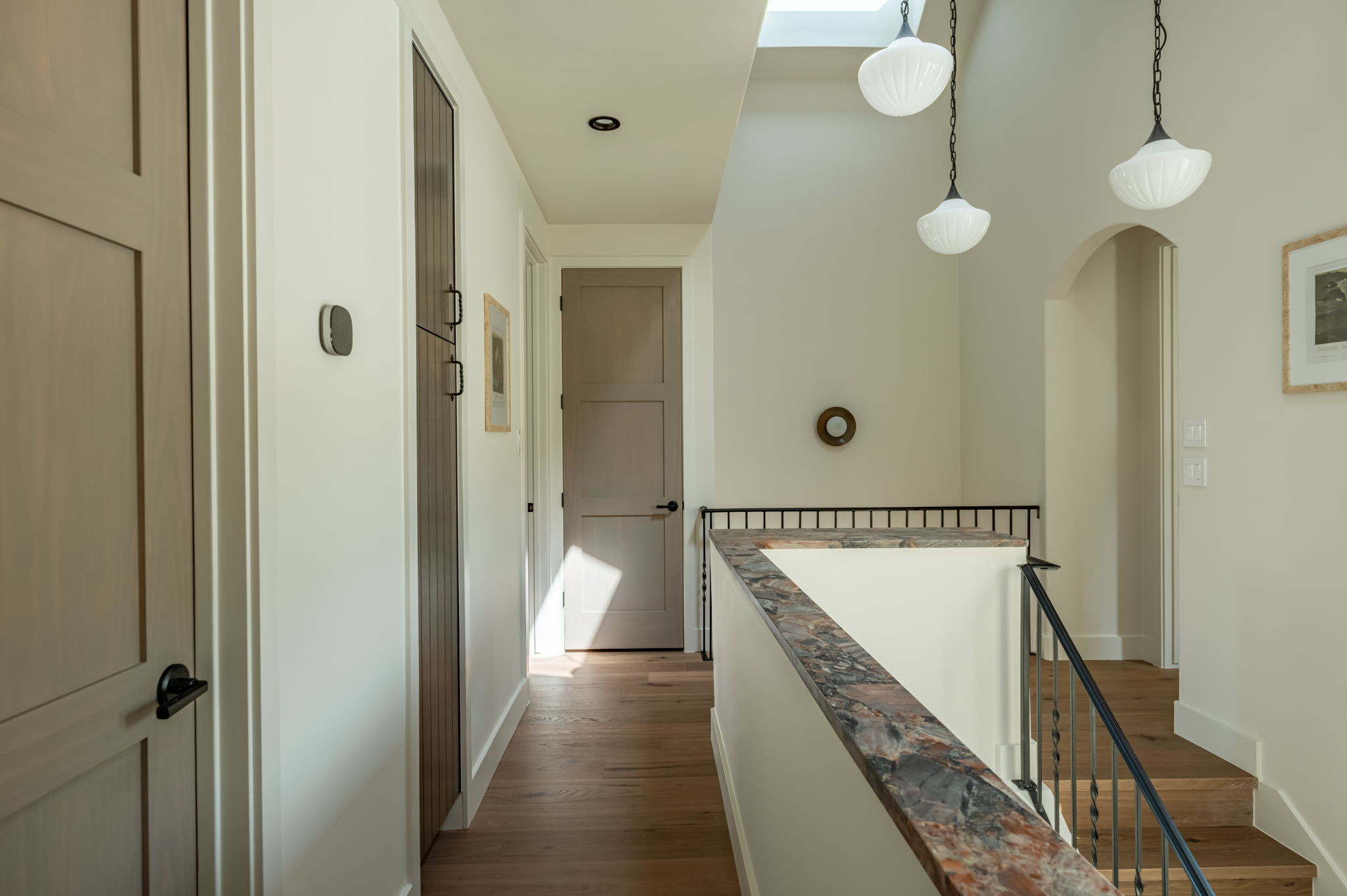 4713 Bolm Road Austin, TX 78702 - Photo 21 of 40 Upper-level hallway with wood-finish flooring, a skylight, and recessed lighting
