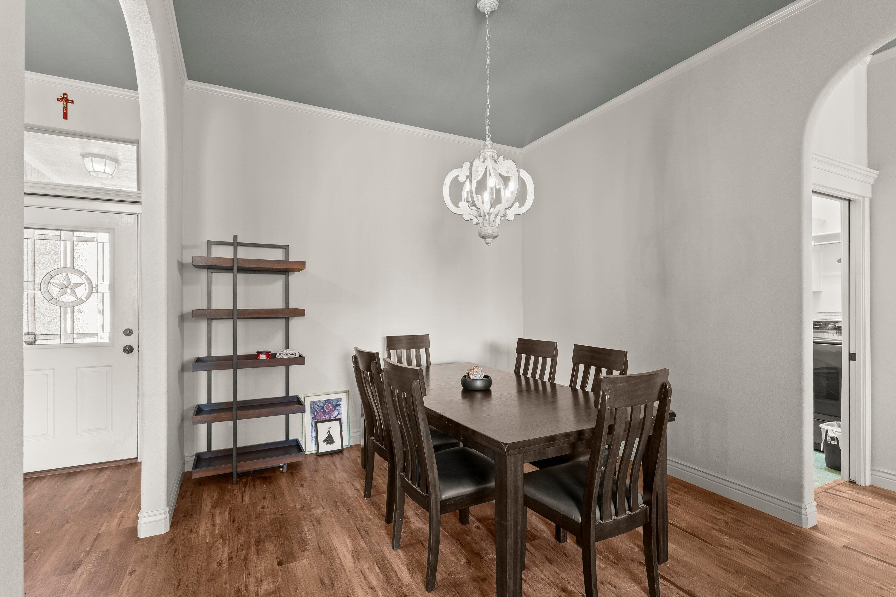 6305 93rd Street Lubbock, TX 79424 - Photo 12 of 31 a view of a dining room with furniture and wooden floor