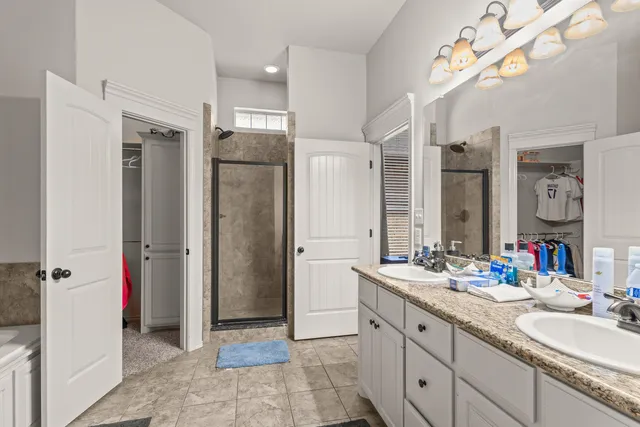 a bathroom with a double vanity sink mirror and double