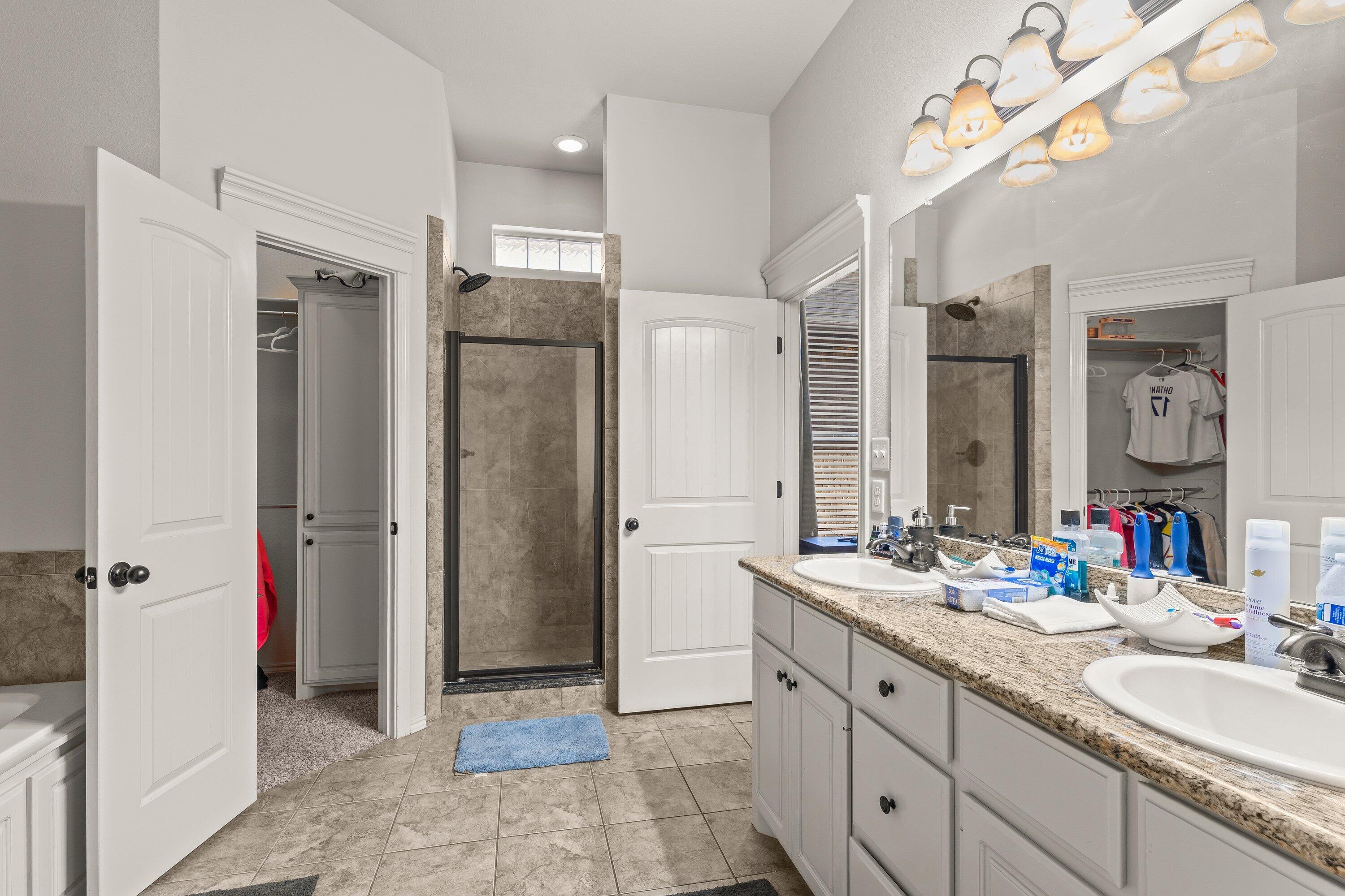 6305 93rd Street Lubbock, TX 79424 - Photo 17 of 31 a bathroom with a double vanity sink mirror and double