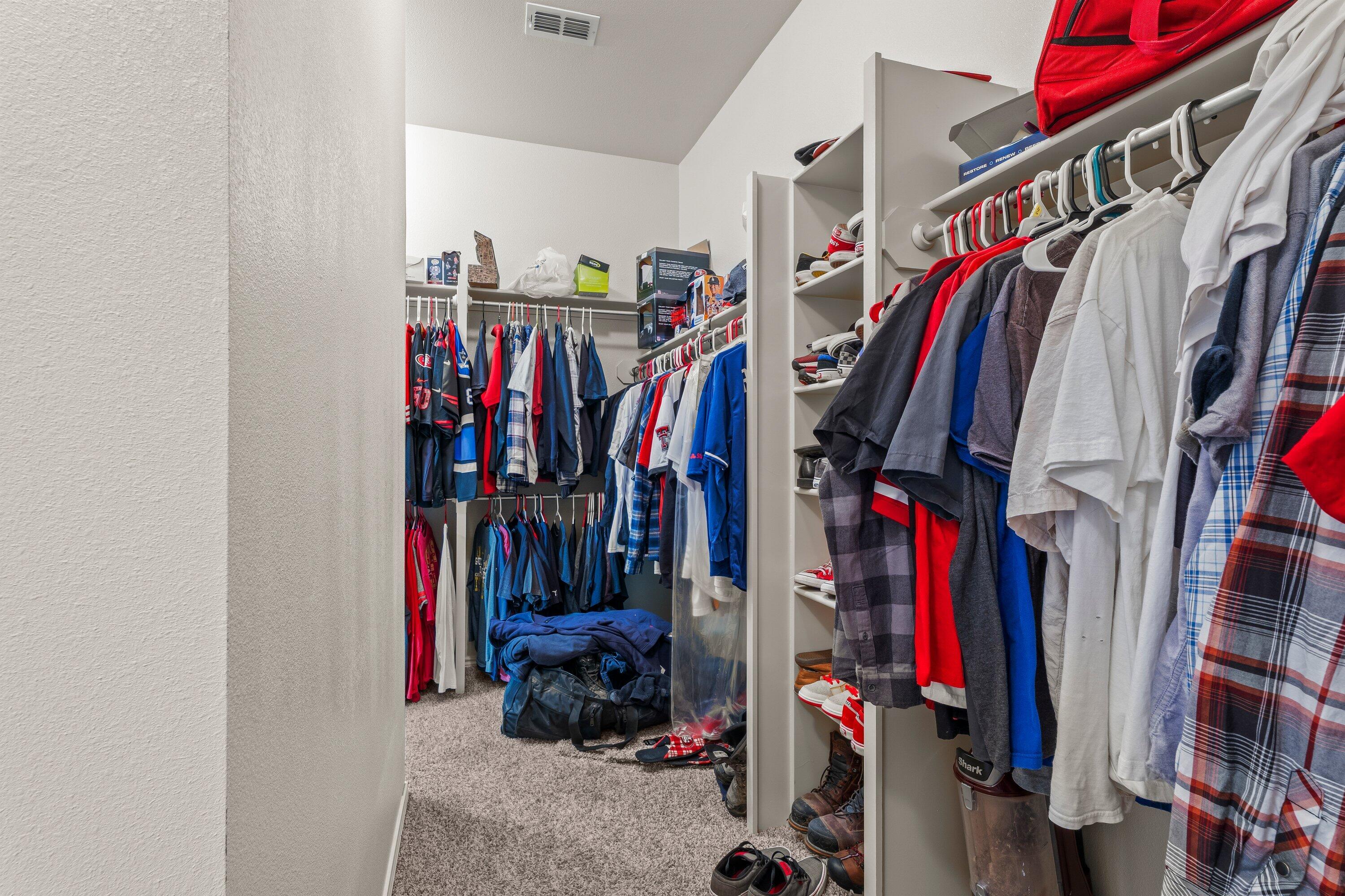 6305 93rd Street Lubbock, TX 79424 - Photo 18 of 31 a view of walk in closet with clothes and shoes