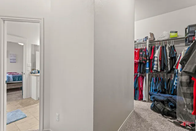 a view of walk in closet with clothes