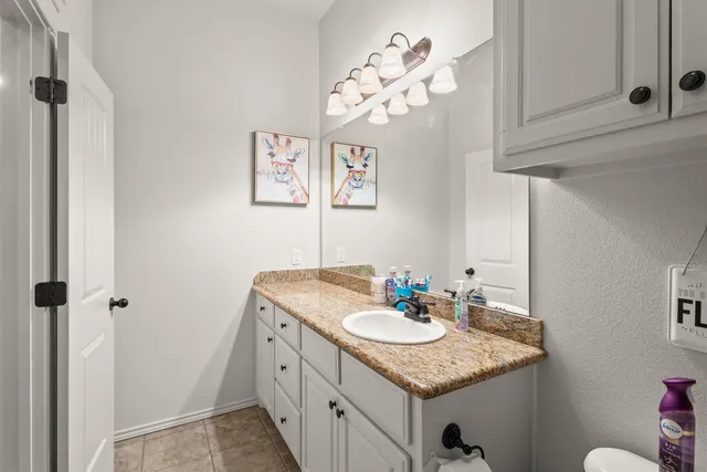 a bathroom with a sink vanity and a mirror