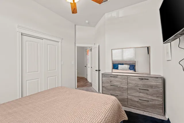 a bedroom with a bed and flat screen tv