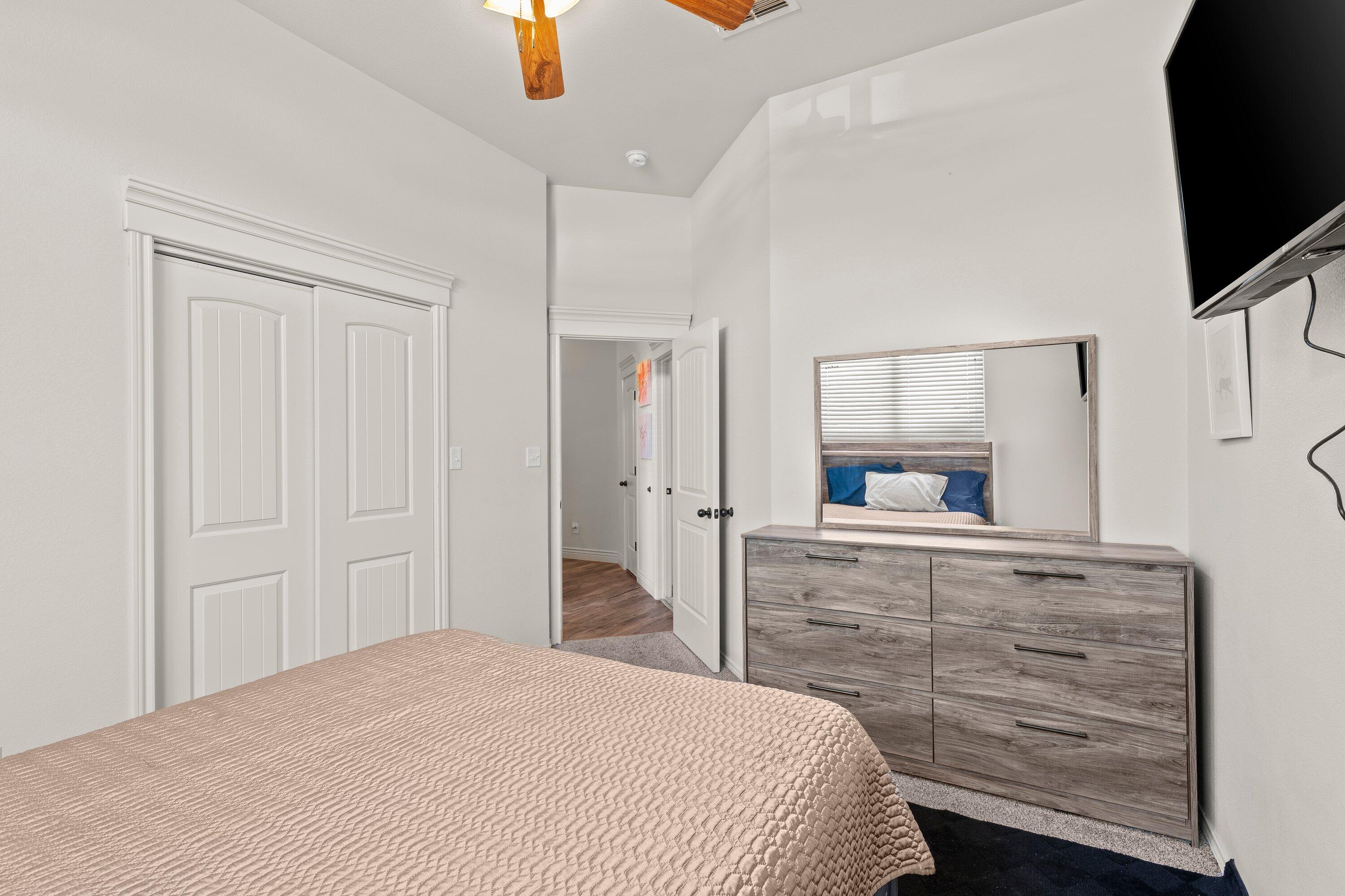 6305 93rd Street Lubbock, TX 79424 - Photo 25 of 31 a bedroom with a bed and flat screen tv