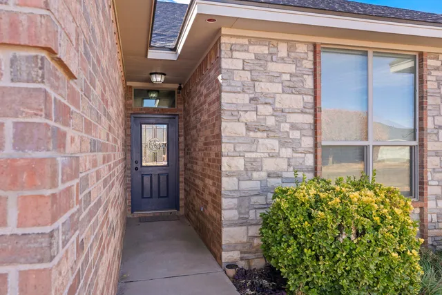 a view of a brick house with a large windows