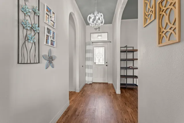 a view of a hallway with wooden floor and entryway