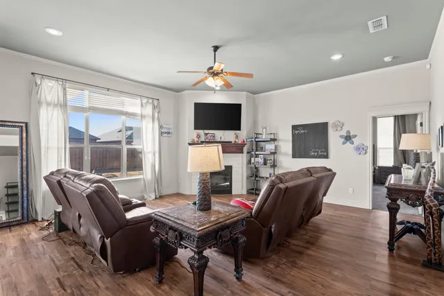 a living room with furniture a flat screen tv and a fireplace